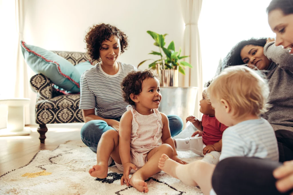 happy family sitting on therapy session by female counselor writing in clipboard in office